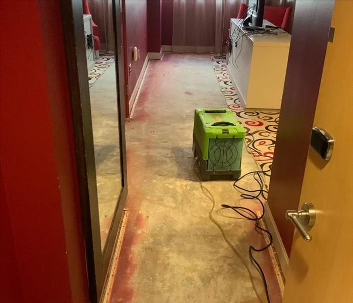 Concrete floor with a green air mover.