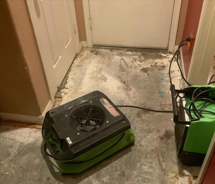 Green air movers on a concrete floor. 