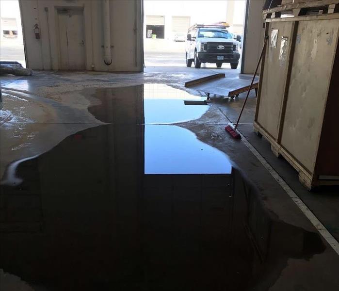 Pooled water on concrete floor. 