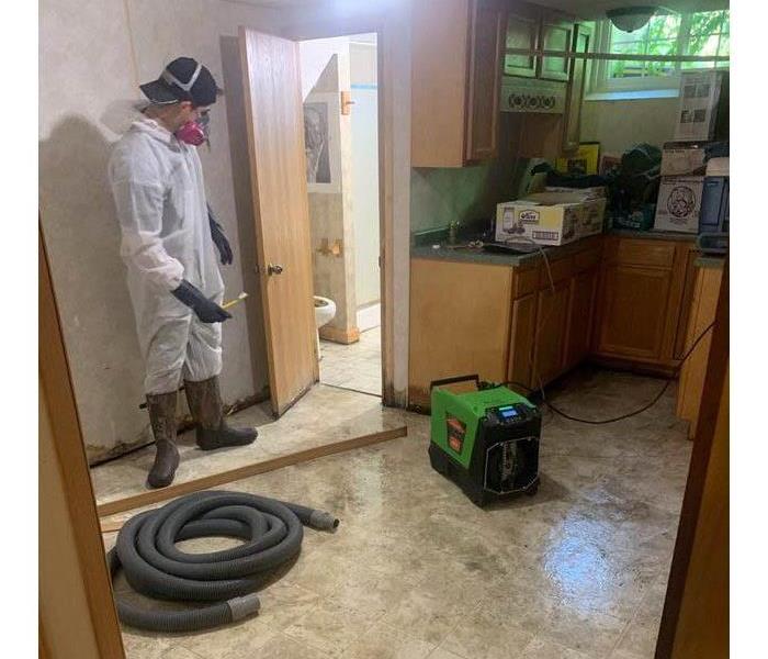 Employee cleaning up water damage.